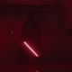 Darth Vader, wielding his lightsaber, bathed in red light and fog.